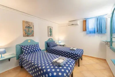 Letto o letti in una camera di Villa degli Angeli - Appartamento Portopinetto