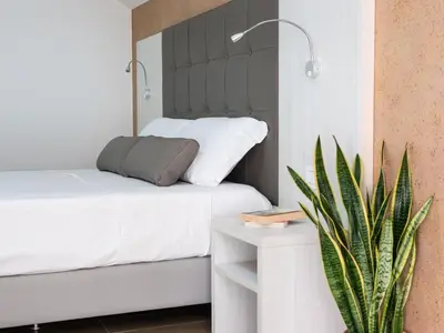 Letto o letti in una camera di Corte dei Limoni - Affittacamere - Living Sant'Antioco