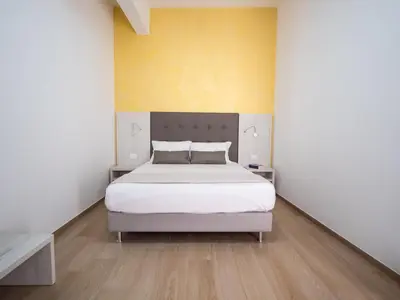 Letto o letti in una camera di Corte dei Limoni - Affittacamere - Living Sant'Antioco