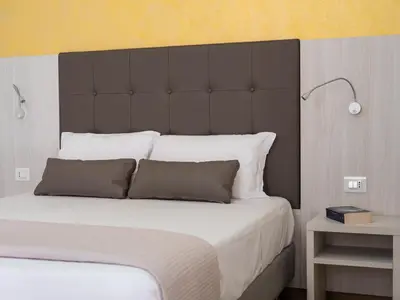 Letto o letti in una camera di Corte dei Limoni - Affittacamere - Living Sant'Antioco