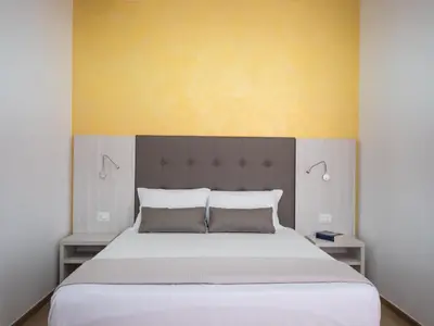 Letto o letti in una camera di Corte dei Limoni - Affittacamere - Living Sant'Antioco