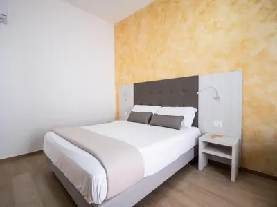 Letto o letti in una camera di Corte dei Limoni - Affittacamere - Living Sant'Antioco