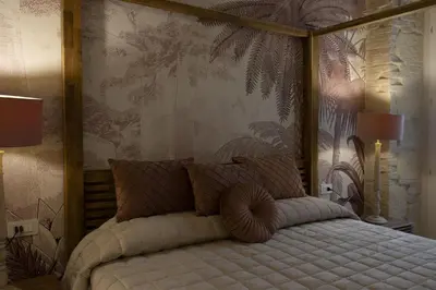 Letto o letti in una camera di La Maison Coloniale Suite e Zona Wellness free