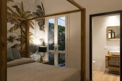 Letto o letti in una camera di La Maison Coloniale Suite e Zona Wellness free