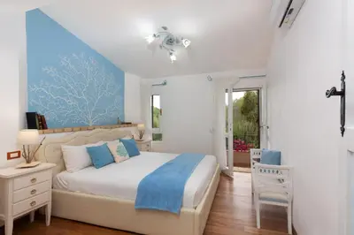 Letto o letti in una camera di Villasimius - Villa Sofia