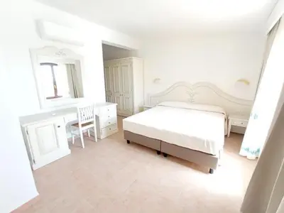 Letto o letti in una camera di Hotel Genna 'e Masoni