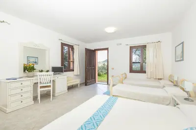 Letto o letti in una camera di Hotel Genna 'e Masoni