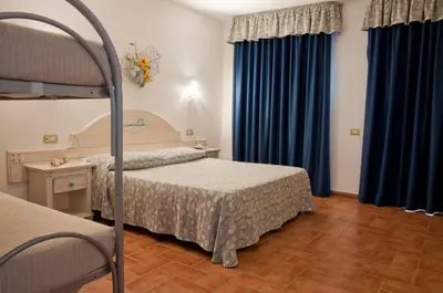 Letto o letti in una camera di Hotel le Sabbie