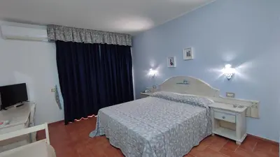 Letto o letti in una camera di Hotel le Sabbie