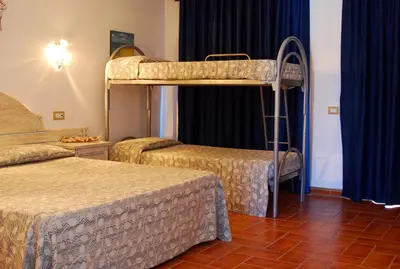 Letto o letti in una camera di Hotel le Sabbie