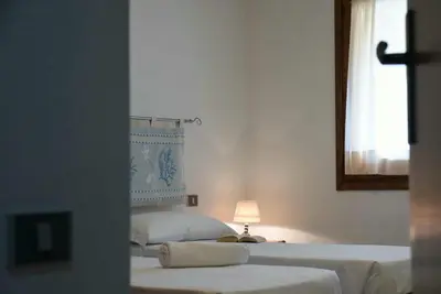 Letto o letti in una camera di Casa Mistral By La Via Del Mare Viaggi e Vacanze