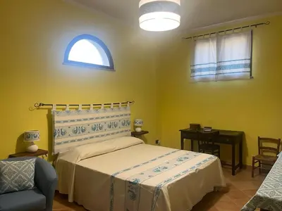 Letto o letti in una camera di Open Space s'Ollastu con WiFi, Patio e Aria Condizionata