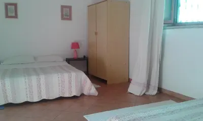 Letto o letti in una camera di Su Furriadroxu Tuerredda