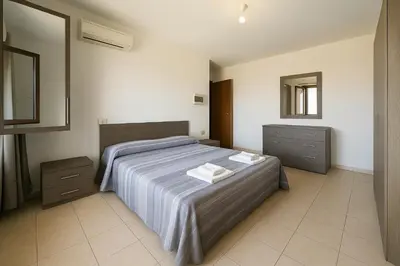 Letto o letti in una camera di Casa Amelia Oristano, 10 minutes from the beaches