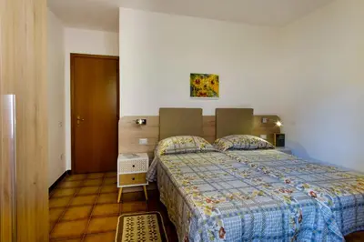 Letto o letti in una camera di Residence Appartamenti Caffarena