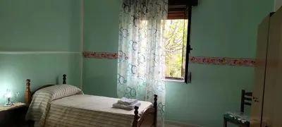Letto o letti in una camera di Casa Vacanze al muro di cinta Carloforte
