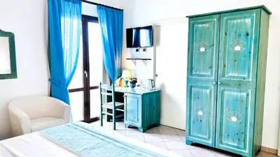 Letto o letti in una camera di La Perla Hotel