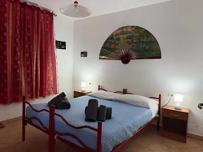 Letto o letti in una camera di Casa Mimosa