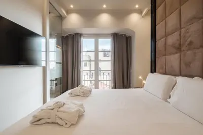 Letto o letti in una camera di Luxury Suites in the Heart of Cagliari