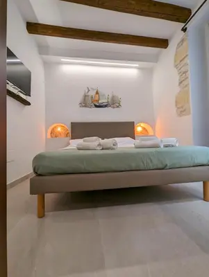 Letto o letti in una camera di Casa di Leda 3