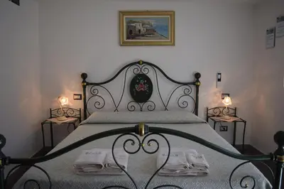 Letto o letti in una camera di B&B Terre del Sinis