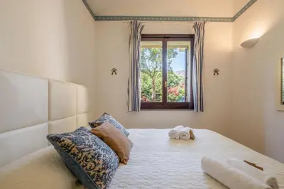 Letto o letti in una camera di Villa Lusso Santa Margherita di Pula 3 Minuti dal Mare