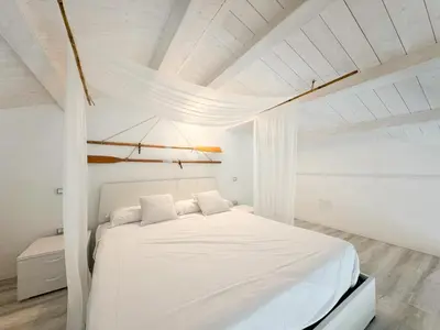 Letto o letti in una camera di Kalma Lux - Sant Efisio Lofts