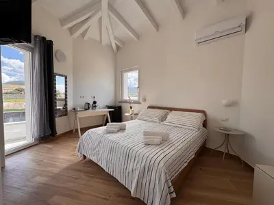 Letto o letti in una camera di Domo Il Tramonto Giba