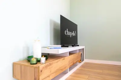 TV o dispositivi per l'intrattenimento presso Chapelle Nove - Green Apartment
