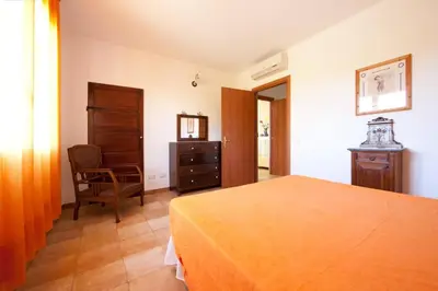 Letto o letti in una camera di Villa Domo Sardo - Masone pardu