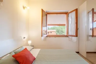 Letto o letti in una camera di 5 minuti a piedi dal mare- appartamento con veranda