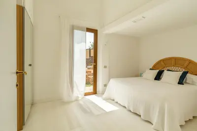 Letto o letti in una camera di Blue Bay Home a pochi passi dalla baia di Porto Luna