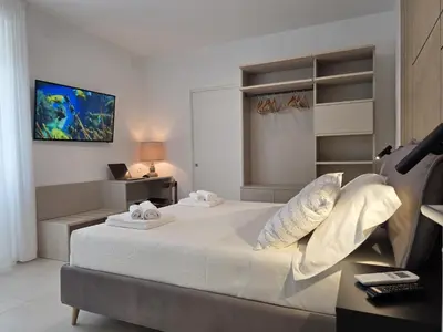 Letto o letti in una camera di UbiMaior Suite - Monte Urpinu apartment with parking