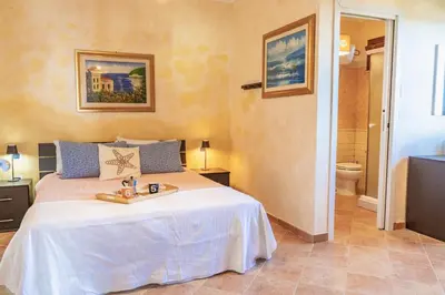 Letto o letti in una camera di Domo de Luxi - Calamenhir - Portoscuso