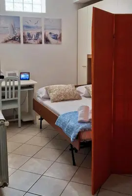 Letto o letti in una camera di Casa Silvana Relax e Mare nel cuore di Sant'Antioco
