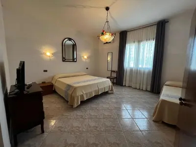 Letto o letti in una camera di Villa Sarcapos Castiadas