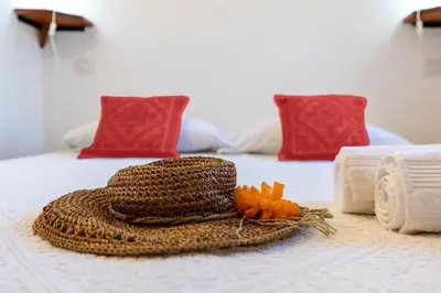 Letto o letti in una camera di Villa con Giardino - Accesso Diretto alla Spiaggia Giunco
