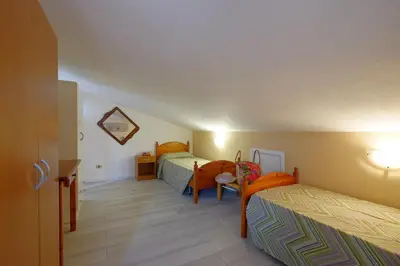 Letto o letti in una camera di Glicine e sole by Teuladaapartments