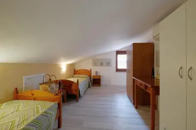 Letto o letti in una camera di Glicine e sole by Teuladaapartments