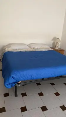 Letto o letti in una camera di casa vacanze Esperu