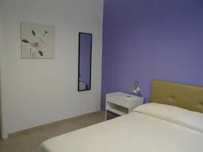 Letto o letti in una camera di Casa Cinzia con piccolo giardino