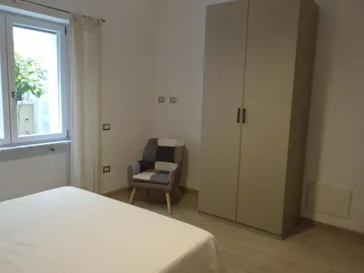 Letto o letti in una camera di Casa Cinzia con piccolo giardino