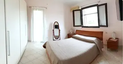 Letto o letti in una camera di Oasi Relax Casa Vacanze Sant'Antioco P1