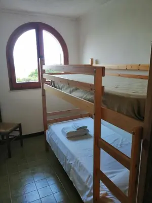 Letto o letti in una camera di La terrazza sul blu - intero appartamento con vista Costa Rei