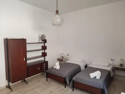 Letto o letti in una camera di Casa Franca - Sant'Antioco a pochi passi dal lungomare - garden, sea and relaxation