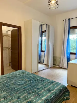 Letto o letti in una camera di casa vacanze I GIARDINI DI VIALE REPUBBLICA