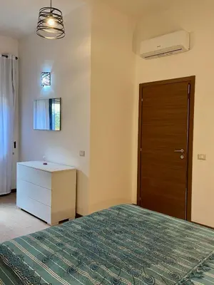 Letto o letti in una camera di casa vacanze I GIARDINI DI VIALE REPUBBLICA