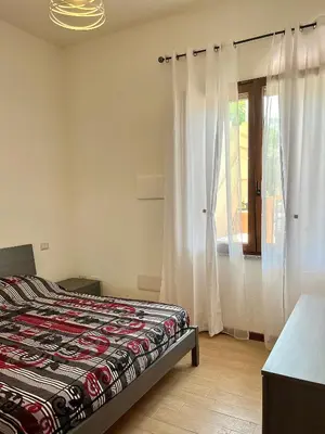Letto o letti in una camera di casa vacanze I GIARDINI DI VIALE REPUBBLICA