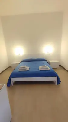 Letto o letti in una camera di casa vacanze I GIARDINI DI VIALE REPUBBLICA