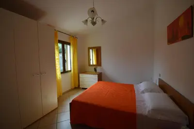 Letto o letti in una camera di Appartamento Panoramico Vista Mare e Montagna